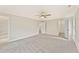 Spacious main bedroom featuring plush carpeting, ceiling fan, and ensuite bathroom and closet at 101 Priestwood Ln, Acworth, GA 30102