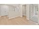 Hallway with hardwood floors leading to the laundry room and a carpeted bedroom at 101 Priestwood Ln, Acworth, GA 30102