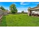 Expansive fenced back yard with lush green grass and patio area at 2239 Noelle Pl, Powder Springs, GA 30127