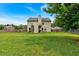 Large grassy backyard featuring a home with solar panels and a wooden fence at 2239 Noelle Pl, Powder Springs, GA 30127