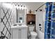 Nicely decorated bathroom with patterned walls, attractive vanity and stylish fish-themed shower curtain at 2239 Noelle Pl, Powder Springs, GA 30127