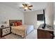 Cozy bedroom with ceiling fan and a view of the front yard at 2239 Noelle Pl, Powder Springs, GA 30127