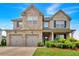 Beautiful two-story brick home with a three car garage and landscaped front yard at 2239 Noelle Pl, Powder Springs, GA 30127