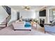 Comfortable living room with a fireplace, large windows, and a staircase at 2239 Noelle Pl, Powder Springs, GA 30127