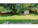 This backyard offers a grass area and a shed for storage and mature trees that provide shade at 315 Marley Dr, Atlanta, GA 30349