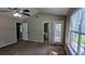 The bedroom features neutral walls, carpet flooring, ceiling fan, and access to the bathroom at 315 Marley Dr, Atlanta, GA 30349