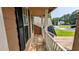 Exterior view of the house features a charming porch with white railing and brown walls at 315 Marley Dr, Atlanta, GA 30349
