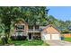 Charming two-story home featuring a spacious front yard and a two-car garage at 315 Marley Dr, Atlanta, GA 30349