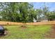 Grassy backyard featuring a new fence for privacy, with mature trees and ample space at 528 Allendale Dr, Decatur, GA 30032