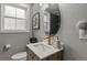 Stylish bathroom features modern vanity with elegant gold fixtures, oval mirror, and a sleek tiled shower at 528 Allendale Dr, Decatur, GA 30032