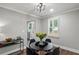 Modern dining room with stylish black table, contemporary light fixture and hardwood floors at 528 Allendale Dr, Decatur, GA 30032