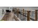Spacious finished loft area featuring wood floors and railing that overlooks the stairwell at 528 Allendale Dr, Decatur, GA 30032