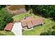 Aerial view showing the sprawling property with a pond, long driveway, and detached garage at 871 Cowan Se Rd, Conyers, GA 30094