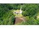 Aerial view of property featuring a pond and wooded lot; creating a private retreat at 871 Cowan Se Rd, Conyers, GA 30094