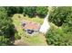Aerial view showcases the home's layout, landscaping, and proximity to the tranquil pond at 871 Cowan Se Rd, Conyers, GA 30094