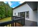 Back deck offers views of lawn and treeline, with French doors to home at 871 Cowan Se Rd, Conyers, GA 30094