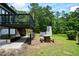 Cozy backyard with a brick fireplace and picnic table; ideal for outdoor entertaining at 871 Cowan Se Rd, Conyers, GA 30094