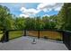 Back deck overlooks peaceful pond, treeline, and sky with fluffy clouds at 871 Cowan Se Rd, Conyers, GA 30094
