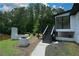 Renovated home featuring a backyard with a brick grill and pond views, perfect for outdoor enjoyment at 871 Cowan Se Rd, Conyers, GA 30094
