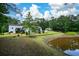 Expansive, lush backyard with a pond view, offering a private retreat at 871 Cowan Se Rd, Conyers, GA 30094