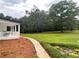 Expansive backyard featuring a well-manicured lawn and mature trees at 871 Cowan Se Rd, Conyers, GA 30094