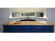Basement bar area features wooden countertop and decorative mirror on the back wall at 871 Cowan Se Rd, Conyers, GA 30094