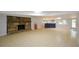 Spacious basement with fireplace, bar area, and tile flooring at 871 Cowan Se Rd, Conyers, GA 30094
