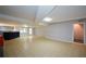 Large finished basement with tile flooring, bar, and walkout access at 871 Cowan Se Rd, Conyers, GA 30094