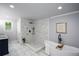 Bathroom featuring marble tiled walk-in shower and a standalone soaking tub with a window at 871 Cowan Se Rd, Conyers, GA 30094