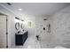 Bathroom featuring a marble tiled walk-in shower, double vanities, and natural light from the window at 871 Cowan Se Rd, Conyers, GA 30094