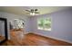 Bright bedroom featuring hardwood floors, a ceiling fan, and an archway leading to a sitting area at 871 Cowan Se Rd, Conyers, GA 30094