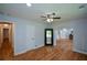 Spacious bedroom featuring hardwood floors, a ceiling fan, and a view of the en-suite bathroom at 871 Cowan Se Rd, Conyers, GA 30094