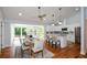 Bright dining area with access to deck, features white cabinets and hardwood floors at 871 Cowan Se Rd, Conyers, GA 30094
