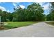 Long driveway leading to home and surrounded by trees and lawn at 871 Cowan Se Rd, Conyers, GA 30094