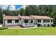 Traditional home featuring a front porch, lush lawn and mature landscaping at 871 Cowan Se Rd, Conyers, GA 30094