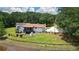 Exterior view of the home with pond and entertaining space; offering a serene setting at 871 Cowan Se Rd, Conyers, GA 30094