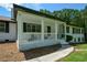 Home featuring a charming front porch with white columns and railing at 871 Cowan Se Rd, Conyers, GA 30094