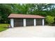Three-car garage with brick columns and a driveway; excellent for car enthusiasts or extra storage at 871 Cowan Se Rd, Conyers, GA 30094