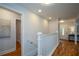 Light-filled hallway with hardwood floors, stairs, and access to other rooms at 871 Cowan Se Rd, Conyers, GA 30094
