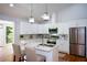 Modern eat-in kitchen with white cabinets, quartz countertops, and stainless steel appliances at 871 Cowan Se Rd, Conyers, GA 30094