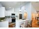 Modern kitchen with white cabinets, stainless steel appliances, and a breakfast bar at 871 Cowan Se Rd, Conyers, GA 30094