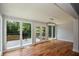 Open living room with hardwood floors and natural light, leading to a deck with beautiful nature views at 871 Cowan Se Rd, Conyers, GA 30094