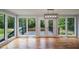 Open living room with hardwood floors and natural light, leading to a deck with beautiful nature views at 871 Cowan Se Rd, Conyers, GA 30094