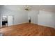 Spacious living room with hardwood floors and a full bathroom in view; features white-painted brick accent wall at 871 Cowan Se Rd, Conyers, GA 30094