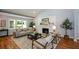 Stylish living room with a brick fireplace, hardwood floors and a neutral color palette at 871 Cowan Se Rd, Conyers, GA 30094