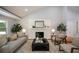 Inviting living room features a white brick fireplace, hardwood floors and neutral furniture at 871 Cowan Se Rd, Conyers, GA 30094