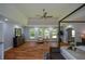 Expansive main bedroom featuring hardwood floors, a ceiling fan, and a comfortable sitting area by the windows at 871 Cowan Se Rd, Conyers, GA 30094