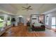 Main bedroom with wood floors, a ceiling fan, lots of light, and access to the ensuite bathroom at 871 Cowan Se Rd, Conyers, GA 30094