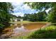 The home is on a private pond surrounded by mature trees and lush greenery, a serene natural oasis at 871 Cowan Se Rd, Conyers, GA 30094