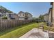 Spacious backyard featuring green lawn, patio area with seating, and a wood privacy fence at 11910 Brightside Pkwy, Hampton, GA 30228